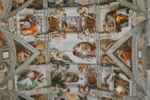 Intricate fresco artwork on the Sistine Chapel ceiling by Michelangelo in Vatican City.